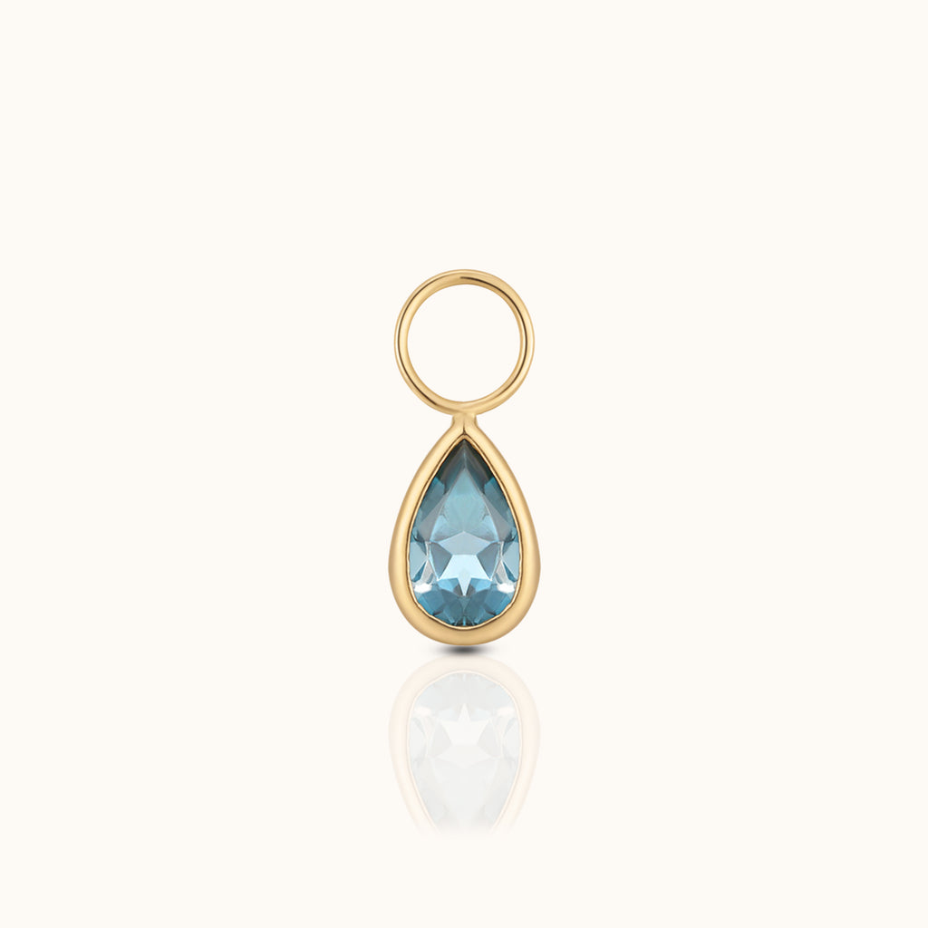 DOVIANA 14K solid gold ear charm with a pear-cut blue topaz gemstone in a polished teardrop bezel setting