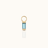 DOVIANA 14K solid gold ear charm with a baguette-cut blue topaz gemstone in a polished geometric setting