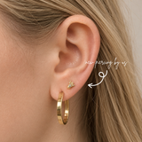 DOVIANA NYC 14K solid gold rocket flat back earring styled in a curated ear piercing with gold hoop earrings for minimalist fine piercing jewelry and everyday ear stacks in New York.