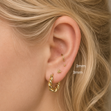 DOVIANA NYC 14K solid gold tri dots threadless flat back earrings shown in 2mm and 3mm sizes on a curated ear stack with gold hoop earrings for everyday piercing jewelry in New York.