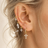 DOVIANA four-petal CZ ear charm crafted from PVD gold titanium and styled on a hoop earring. Lightweight, hypoallergenic charm only; hoop not included.