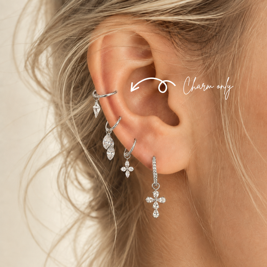 DOVIANA kite-cut CZ ear charm made from silver-tone titanium, shown on a hoop in a curated ear stack. Charm sold individually; hoop not included.