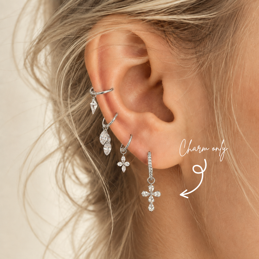 DOVIANA pear-cut CZ cross ear charm made from silver-tone titanium, styled on a pavé hoop earring. Charm sold individually; hoop not included.