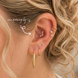 Fresh conch piercing by DOVIANA NYC featuring a gold marquise cluster earring, professionally pierced and styled with luxury cartilage jewelry in Manhattan, New York.