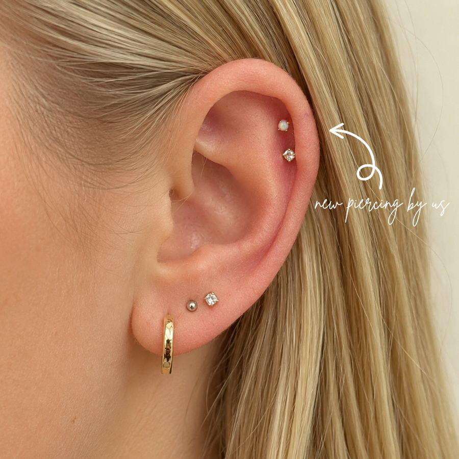 DOVIANA 14K Solid Gold 2mm Opal Threadless Flat Back Earring styled in a fresh helix piercing, featuring a luminous opal gemstone and professional ear styling in Manhattan, New York.