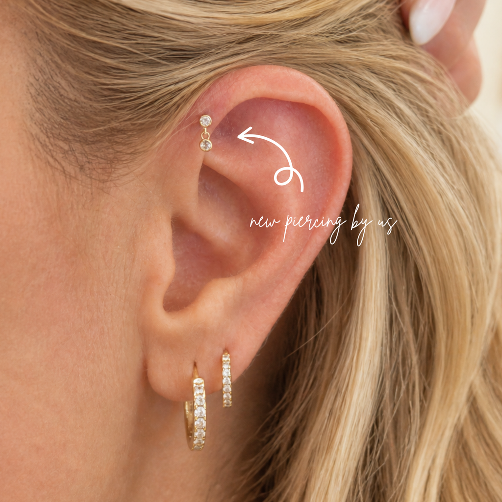 Close-up of ear wearing DOVIANA 14K solid gold double bezel round CZ drop threadless labret flat back earring, showcasing dainty cartilage piercing jewelry with a minimal elegant drop design for everyday wear.
