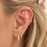 Close-up of ear wearing DOVIANA 14K solid gold double bezel round CZ drop threadless labret flat back earring, showcasing dainty cartilage piercing jewelry with a minimal elegant drop design for everyday wear.