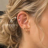 Close-up helix piercing styled with DOVIANA 14K Solid Gold Pear CZ Drop Threadless Labret Flat Back Earring featuring a dangling pear-shaped cubic zirconia design in a curated ear stack.