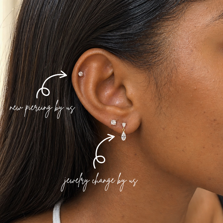 Close-up lobe piercing styled with DOVIANA 14K Solid Gold Pear CZ Drop Threadless Labret Flat Back Earring featuring a dangling pear-shaped cubic zirconia drop in a minimalist curated ear stack.