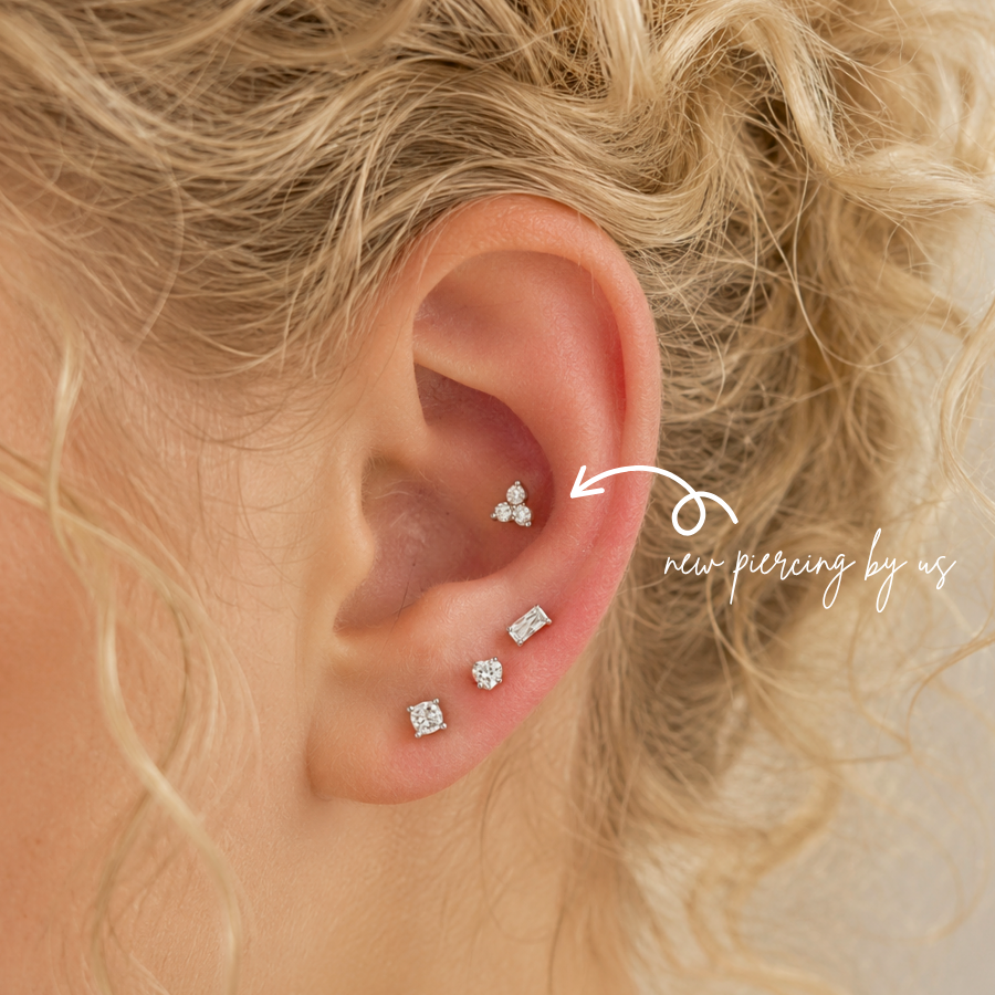 DOVIANA 14K Solid Gold Trefoil CZ Threadless Flat Back Earring styled in a fresh conch piercing, featuring a three-stone CZ cluster and professional ear styling in Manhattan, New York.