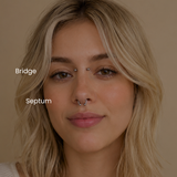 Close-up portrait featuring bridge piercing and septum piercing with implant grade titanium jewelry styled in a minimalist body piercing aesthetic at DOVIANA NYC.