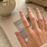 DOVIANA Geometric Cutting Beveled Triangle Polished Titanium PVD Gold Band Ring featuring a faceted geometric design and polished gold finish, styled on a hand for everyday minimalist jewelry wear.