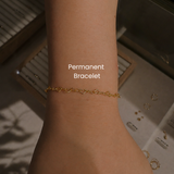 Close-up of gold filled permanent bracelet with heart chain links welded at DOVIANA NYC featuring minimalist forever jewelry and custom permanent bracelet service.