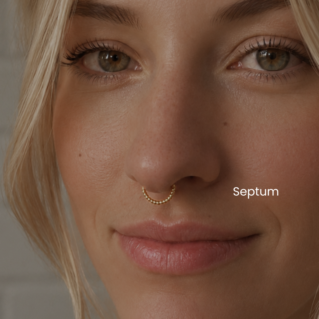 Close-up of septum piercing with gold beaded clicker ring jewelry styled in a minimalist facial piercing aesthetic at DOVIANA NYC.