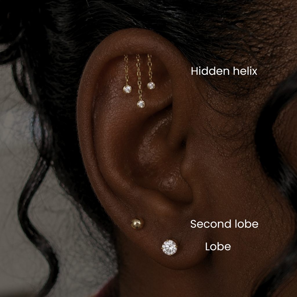 Hidden helix piercing service at DOVIANA featuring 14K solid gold chandelier tassel CZ bezel drop dangle threadless labret flat back earring, luxury cartilage piercing in NYC for sensitive ears