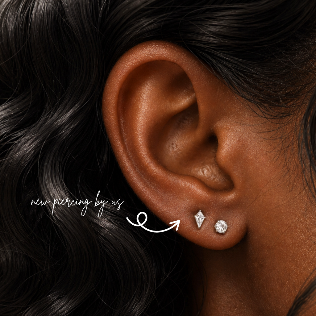 Close-up of a black woman with soft romantic black waves wearing DOVIANA kite shaped CZ threadless labret flat back earring in titanium silver color, styled in a curated ear stack with diamond studs, showcasing dainty fine jewelry for everyday wear.