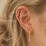 Close-up of a healed helix piercing featuring DOVIANA Large Moon Crescent Threadless Labret Titanium PVD Gold Flat Back Earring styled with gold hoop earrings in a curated ear stack.