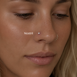 Close-up of nostril piercing with diamond nose stud and gold nose hoop styled in a minimalist facial piercing aesthetic at DOVIANA NYC.