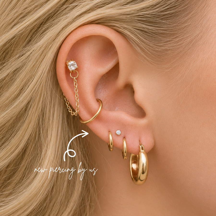 DOVIANA NYC curated ear piercing featuring a crystal chain cartilage earring, gold hoops, CZ lobe stud, and minimalist gold piercing jewelry for everyday ear stacks in New York.