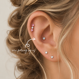 Fresh conch piercing by DOVIANA NYC featuring an implant-grade titanium flat back stud, professionally pierced and styled with cartilage earrings in New York City.