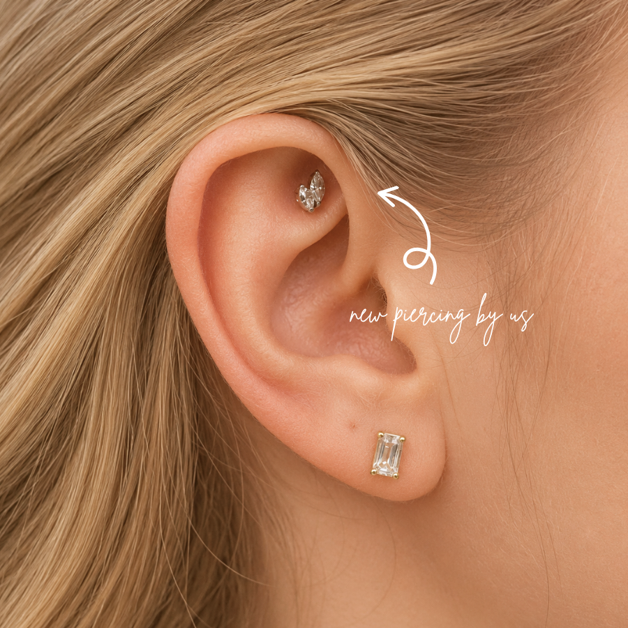 DOVIANA NYC curated ear piercing featuring a crystal leaf cartilage stud, emerald cut lobe earring, and minimalist fine piercing jewelry for everyday ear stacks in New York.