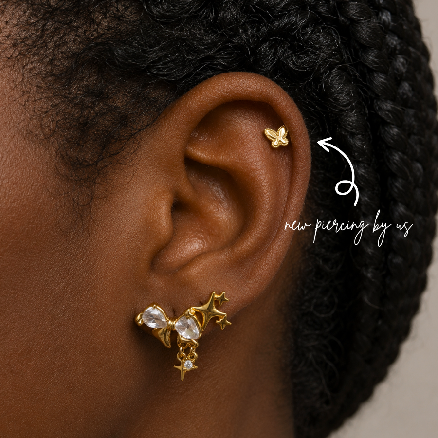 DOVIANA NYC curated ear piercing featuring a gold butterfly cartilage stud, star charm earring, crystal lobe jewelry, and minimalist gold piercing jewelry for everyday ear stacks in New York.