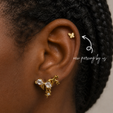 DOVIANA NYC curated ear piercing featuring a gold butterfly cartilage stud, star charm earring, crystal lobe jewelry, and minimalist gold piercing jewelry for everyday ear stacks in New York.