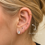 DOVIANA NYC curated ear piercing featuring gold hoop earrings, mixed gold and silver ball studs, crystal lobe stud, and minimalist piercing jewelry for everyday ear stacks in New York.