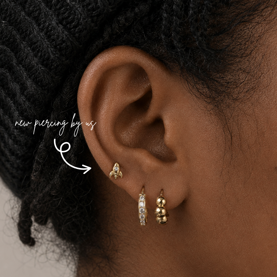 DOVIANA NYC curated ear piercing featuring a gold rocket stud, pavé huggie hoop, gold bead hoop, and minimalist piercing jewelry for everyday ear stacks in New York