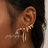 DOVIANA NYC heart flat back earring styled in a curated ear piercing with gold hoop, pearl huggie, bow earring, and minimalist gold piercing jewelry in New York.