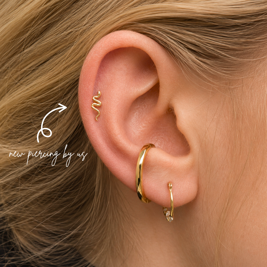 DOVIANA NYC curated ear piercing featuring a gold snake cartilage stud, gold conch hoop, crystal lobe hoop, and minimalist piercing jewelry for everyday ear stacks in New York.