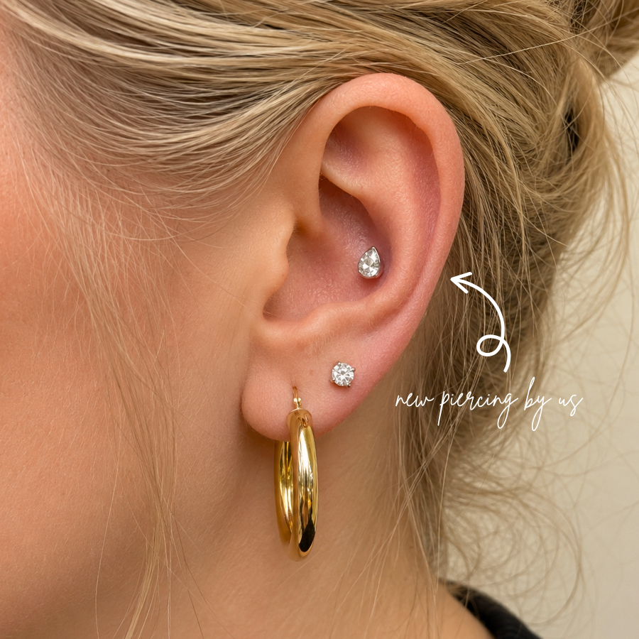 DOVIANA NYC curated ear piercing featuring a teardrop CZ cartilage stud, CZ lobe stud, gold hoop earring, and minimalist piercing jewelry for everyday ear stacks in New York.