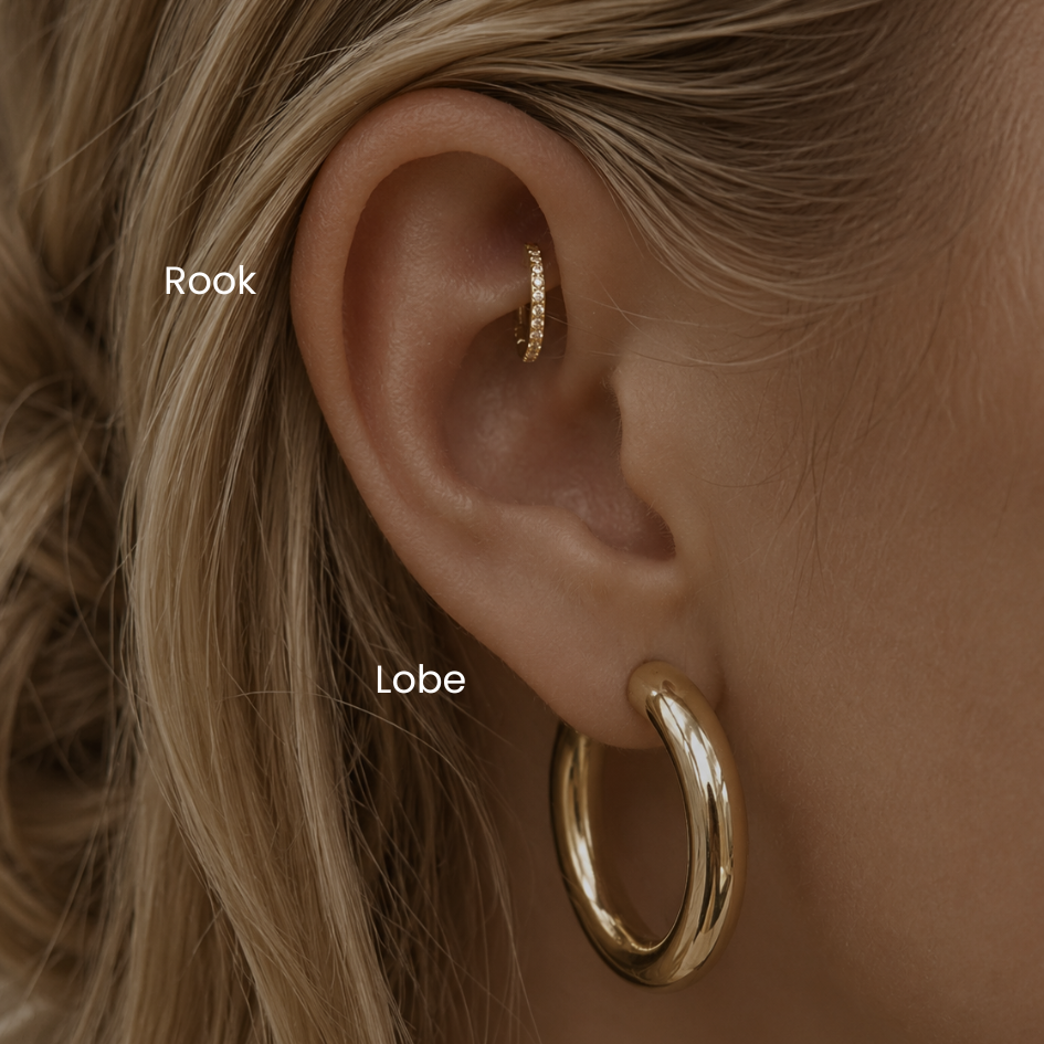 Close-up of rook piercing with diamond gold clicker hoop and gold lobe hoop earrings styled in a minimalist curated ear aesthetic at DOVIANA NYC.