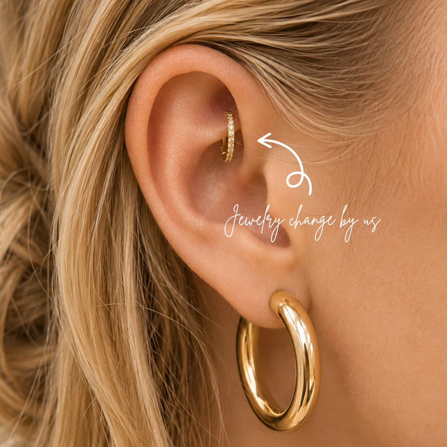 Close-up of rook piercing with cz gold clicker hoop and chunky gold earrings styled in a minimalist curated ear aesthetic at DOVIANA NYC.