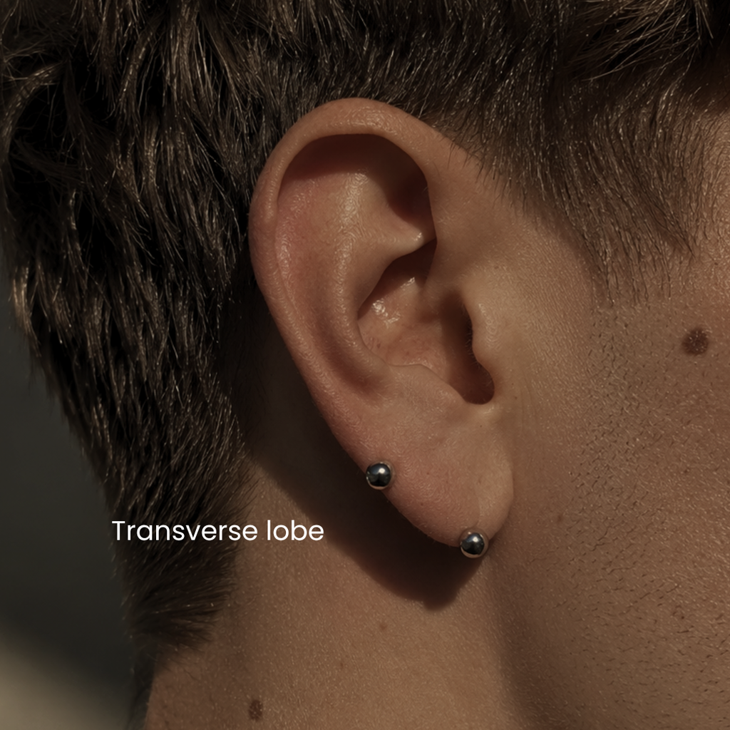 Men’s transverse lobe piercing by DOVIANA featuring implant-grade titanium barbell jewelry with professional needle piercing service and curated ear styling in NYC.