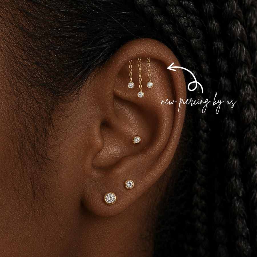 DOVIANA NYC hidden helix chain dangle earring styled in a curated ear piercing with gold CZ bezel studs and minimalist fine piercing jewelry for everyday ear stacks in New York.