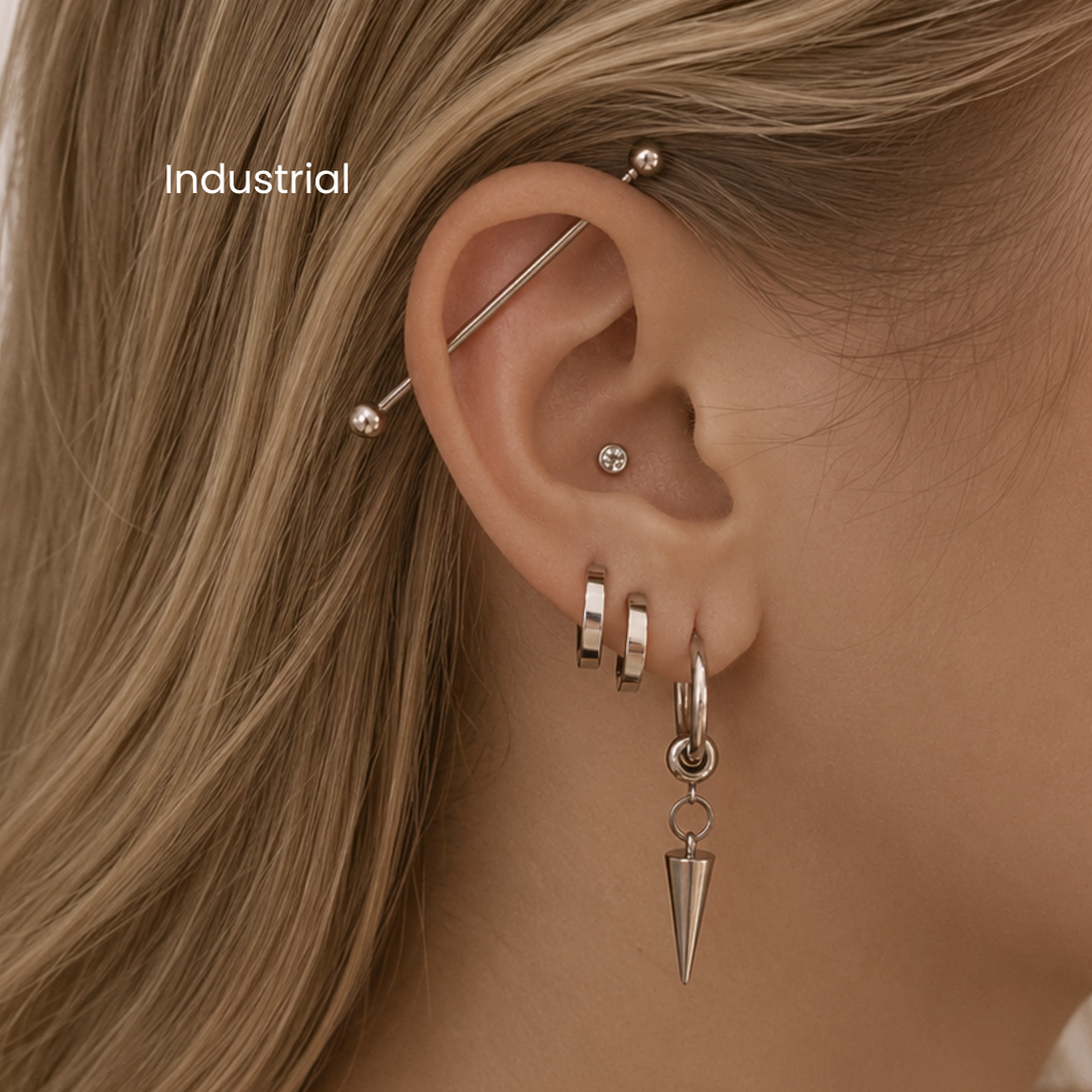 DOVIANA NYC industrial piercing service featuring a silver barbell across the upper ear with curated silver ear jewelry for professional ear piercings in New York.