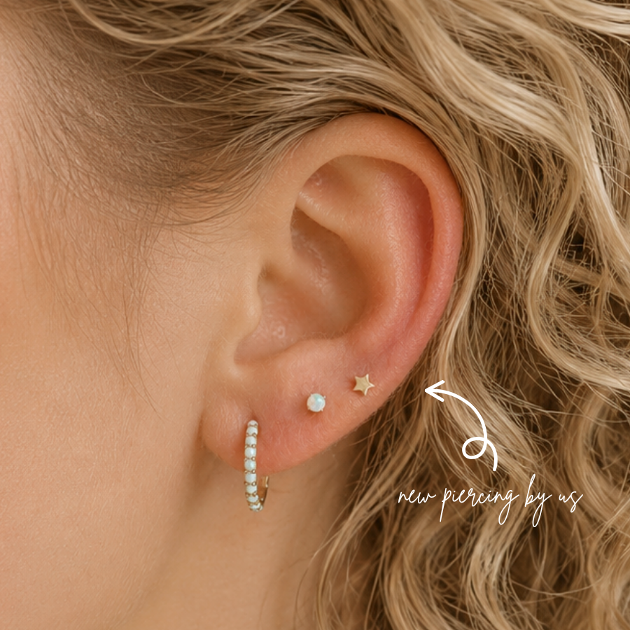 DOVIANA 14K Solid Gold Petite Star Threadless Flat Back Earring styled in a fresh second lobe piercing at a luxury ear piercing and jewelry studio in Manhattan, New York.