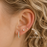 DOVIANA 14K Solid Gold Petite Star Threadless Flat Back Earring styled in a fresh second lobe piercing at a luxury ear piercing and jewelry studio in Manhattan, New York.