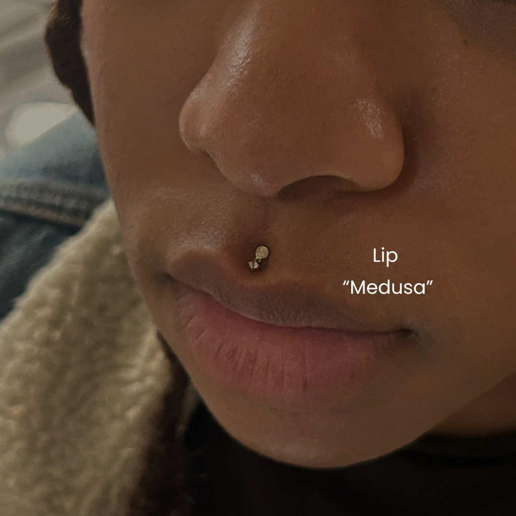 DOVIANA NYC lip piercing service featuring a Medusa piercing with opal and CZ flat back jewelry for professional body piercings in New York, needle piercing only.