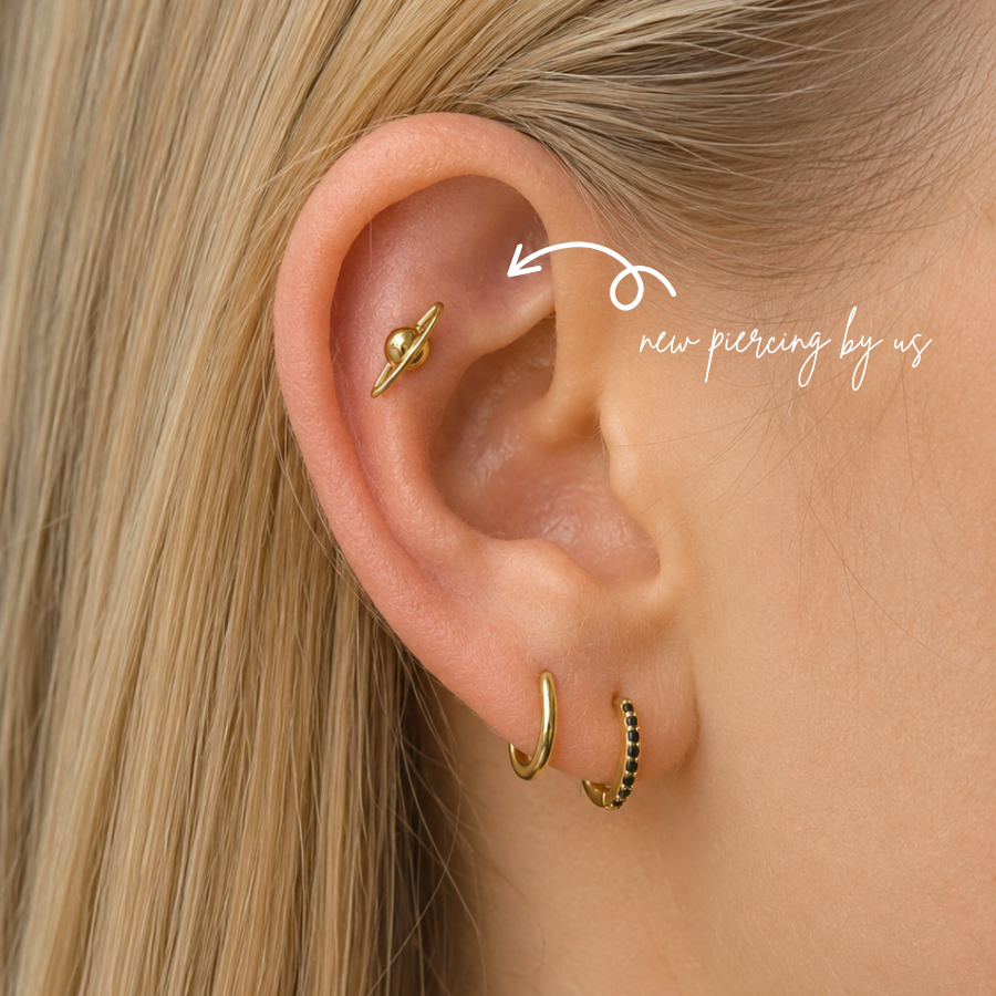 Fresh rook piercing by DOVIANA NYC in Manhattan, New York, featuring a gold rook earring, professional cartilage piercing services, and personalized ear styling.
