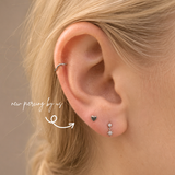 DOVIANA NYC titanium heart flat back earring styled in a silver curated ear piercing with a delicate star drop earring and minimalist piercing jewelry for everyday ear stacks in New York.