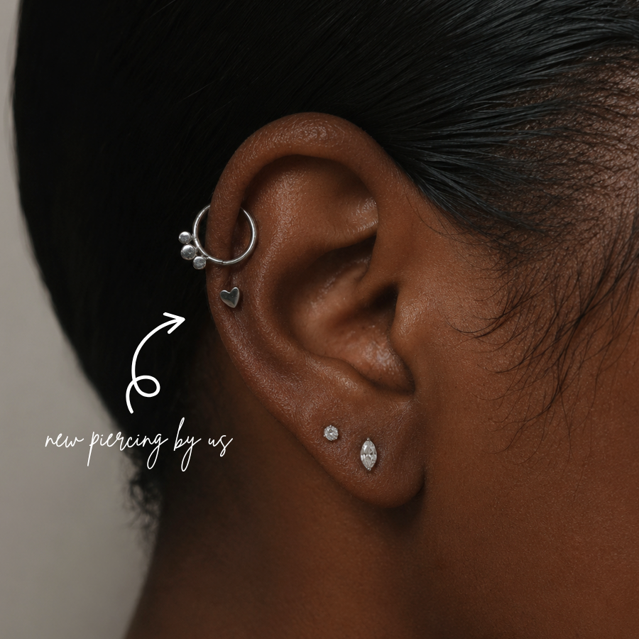DOVIANA NYC titanium heart flat back earring styled in a silver curated ear piercing with helix hoop, CZ stud, marquise lobe stud, and minimalist piercing jewelry in New York.