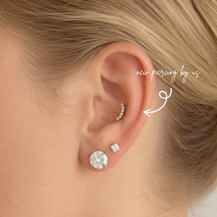 DOVIANA NYC titanium smiley curved flat back earring styled in a curated ear piercing with CZ lobe studs for minimalist everyday piercing jewelry in New York.