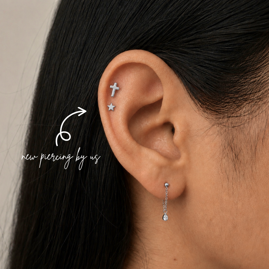 DOVIANA NYC titanium star flat back earring styled in a silver curated ear piercing with a cross cartilage stud and delicate drop earring for minimalist everyday piercing jewelry in New York.