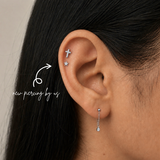 DOVIANA NYC titanium star flat back earring styled in a silver curated ear piercing with a cross cartilage stud and delicate drop earring for minimalist everyday piercing jewelry in New York.